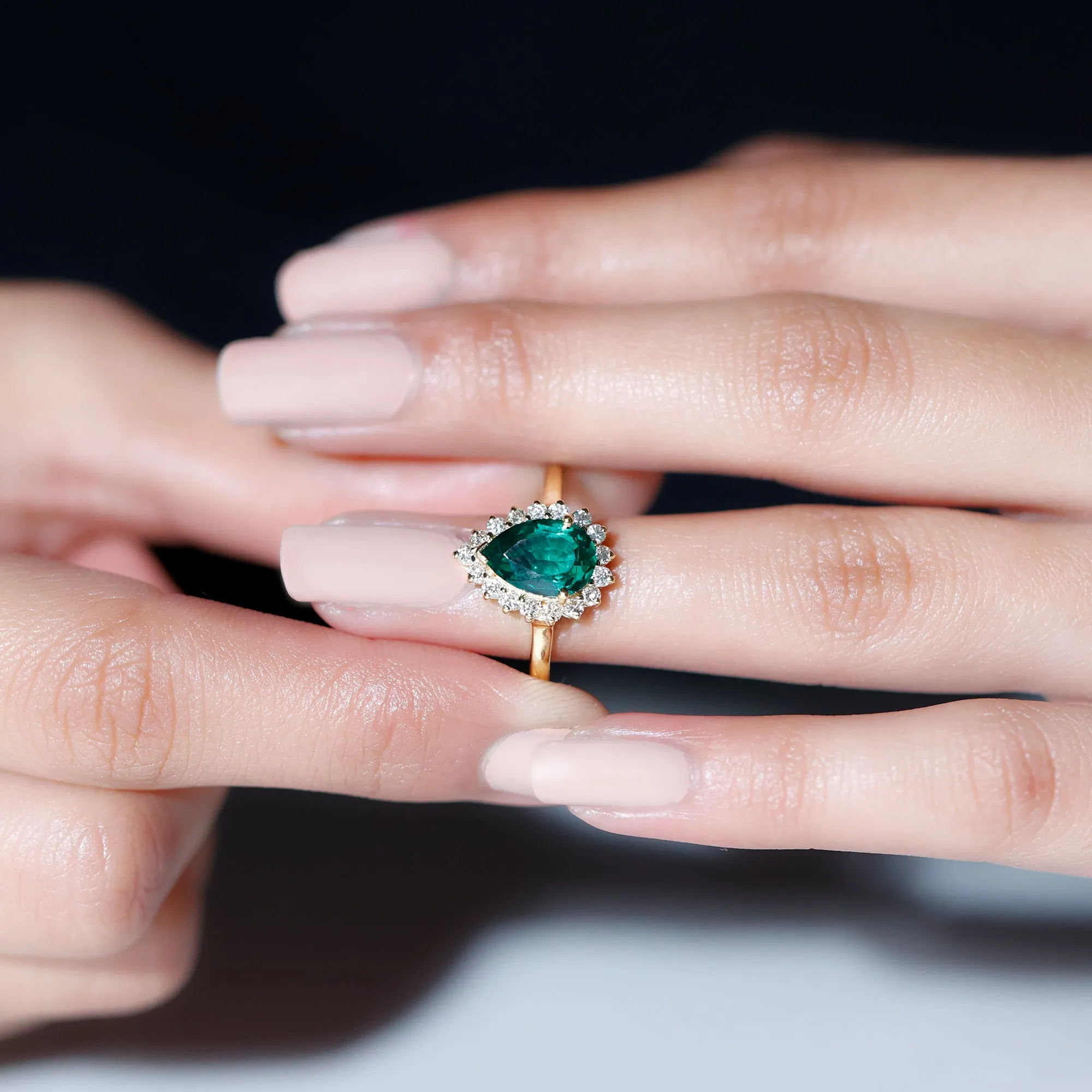 Pear Created Emerald and Diamond Halo Engagement Ring